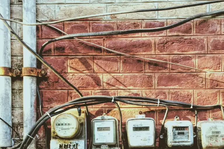 A row of prepaid electricity meters on a wall